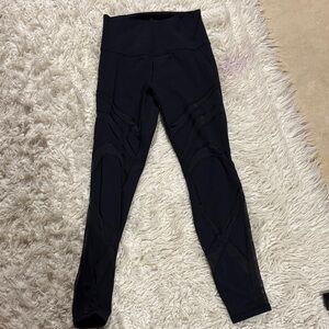 Lululemon Black High-Waisted Leggings with sheer details.